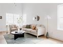 Bright living room with neutral tones, plush seating, and modern decor evokes a serene and inviting atmosphere at 4264 Thorndyke Pl, Broomfield, CO 80020