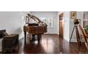 Elegant living room featuring a grand piano, beautiful wood floors, and a cozy seating area at 449 S Humboldt St, Denver, CO 80209