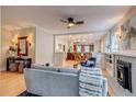 Open-concept living room with hardwood floors, a ceiling fan, and seamless flow to the dining area at 840 S Corona St, Denver, CO 80209