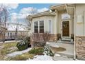 Charming exterior featuring a stone-accented facade and well-maintained landscaping at 2601 S Kipling Ct, Lakewood, CO 80227