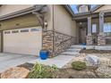 Inviting front exterior showcases a two-car garage, stone accents, and a landscaped walkway leading to the entrance at 15831 Lavender Pl, Broomfield, CO 80023