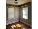 Cozy bedroom featuring hardwood floors, two windows with blinds, and a built-in shelf at 2134 S Corona St, Denver, CO 80210