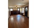 Spacious living room with hardwood floors, fireplace, ceiling fan, and original features at 2134 S Corona St, Denver, CO 80210