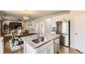 Modern kitchen island with granite countertops, stainless steel appliances, and open layout at 12749 Horton Ct, Parker, CO 80134