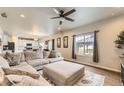 Bright and airy living room with a large sectional sofa and backyard view at 12749 Horton Ct, Parker, CO 80134