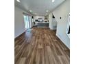 Spacious living room with sliding glass doors, hardwood floors, and an open view to the kitchen at 5060 N Walden Way, Denver, CO 80249