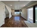 Bright living room featuring hardwood floors, recessed lighting, and sliding glass door at 5060 N Walden Way, Denver, CO 80249