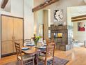 Dining room with hardwood floors, exposed beam, stone fireplace and custom built-in storage at 2107 Ridge Plaza Dr, Castle Rock, CO 80108