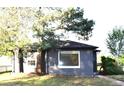 Charming single-story home with a brick exterior, well-maintained landscaping, and bright window trim at 1300 Spruce St, Denver, CO 80220