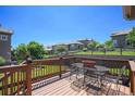 Outdoor deck featuring metal table and seating with backyard view at 22002 E Irish Dr, Aurora, CO 80016