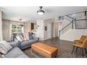 Spacious living room with modern decor, sleek hardwood floors, and staircase at 22002 E Irish Dr, Aurora, CO 80016