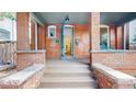 Inviting front entrance with brick steps, detailed stonework, and an open doorway at 588 S Grant St, Denver, CO 80209