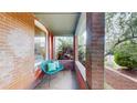 Cozy covered porch with brick accents, comfortable seating, and a relaxing outdoor space at 588 S Grant St, Denver, CO 80209