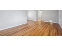 Bright living room with light gray walls and beautiful hardwood floors throughout at 1934 Macon St, Aurora, CO 80010