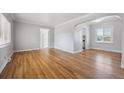 Spacious living room featuring gleaming hardwood floors and ample natural light at 1934 Macon St, Aurora, CO 80010