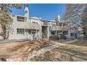 Exterior of condo building showing siding, landscaping and mature trees on a sunny day at 922 S Walden Street St # 103, Aurora, CO 80017