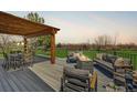 Outdoor deck area with pergola, dining table, sofa and firepit, perfect for entertaining or relaxing at 5855 Rustic Knolls Dr, Boulder, CO 80301