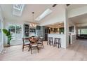 Cozy dining room with a stylish light fixture, skylights, and an open layout, blending modern design at 5855 Rustic Knolls Dr, Boulder, CO 80301