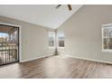 Bright living room features wood-look floors, vaulted ceilings, and ample natural light at 3844 S Gibralter St, Aurora, CO 80013