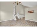 Inviting living room with staircase and neutral paint, featuring stylish wood-look flooring at 3844 S Gibralter St, Aurora, CO 80013