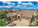 An aerial view of a house with a large yard, two-car garage, and mountain views at 10443 Skyreach Way, Highlands Ranch, CO 80126