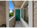 Condo front door with green paint and covered porch at 8378 S Upham Way # B205, Littleton, CO 80128