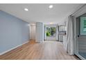 Open living space with hardwood floors, light blue walls, and ample natural light at 8378 S Upham Way # B205, Littleton, CO 80128