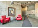 Building lobby with red chairs, side table, and mailboxes at 290 W 12Th Ave # 401, Denver, CO 80204