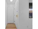 Bright entryway with a white door, closet and wood flooring at 3663 S Sheridan Blvd # I8, Denver, CO 80235
