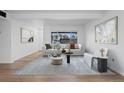 Contemporary living room with ample natural light, a stylish seating arrangement, and a view of the outside at 3663 S Sheridan Blvd # I8, Denver, CO 80235