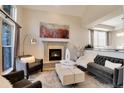 Inviting living room with cozy fireplace, stylish decor, and ample natural light, perfect for relaxation and entertaining at 9629 Silent Hills Ln, Lone Tree, CO 80124