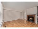 Bright living room with hardwood floors and a charming brick fireplace at 18577 E Whitaker Cir # C, Aurora, CO 80015