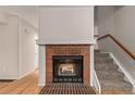 Living room view of fireplace with logs and stairway at 18577 E Whitaker Cir # C, Aurora, CO 80015