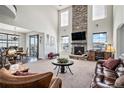 Open living space featuring a fireplace and high ceilings at 11898 Discovery Cir, Parker, CO 80138