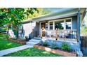 Updated gray home with a welcoming porch and landscaping at 3061 S Grant St, Englewood, CO 80113