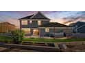 Landscaped backyard with a hot tub, patio, and grassy area perfect for outdoor entertaining and relaxation at 9515 E 109Th Cir, Commerce City, CO 80640