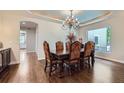 Formal dining room with elegant chandelier, ornate table set, and sky-painted ceiling at 7452 S Utica St, Littleton, CO 80128