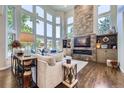 Bright living room featuring a wall of windows, fireplace, and modern furnishings at 7452 S Utica St, Littleton, CO 80128