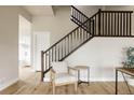 Comfortable sitting area with wooden floors adjacent to carpeted stairs at 6303 Elmira St, Denver, CO 80238