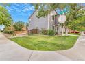 Home's exterior features lush lawn, trees and decorative plantings, and a wooden fence with brick and stone accents at 5320 E 100Th Dr, Thornton, CO 80229