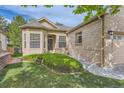 Inviting front entrance with well-kept lawn and manicured landscaping on a sunny day at 29 Woodland Cir, Highlands Ranch, CO 80126