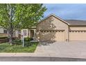 Beautiful brick home with well-maintained front lawn, mature tree, and a three-car garage at 29 Woodland Cir, Highlands Ranch, CO 80126