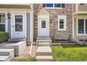 Inviting entrance with stone facade and well-manicured lawn, perfect curb appeal at 1240 S Idalia St, Aurora, CO 80017