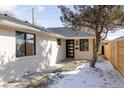 Charming single-story home featuring a light brick exterior, new roof, and modern front door at 1360 Wolff St, Denver, CO 80204