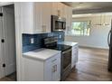 Modern kitchen with white cabinets, stainless steel appliances, and sleek countertops at 6500 W 32Nd Ave, Wheat Ridge, CO 80033