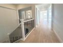 Modern staircase with black metal balusters and light hardwood flooring at 3904 Treadway Pt, Castle Rock, CO 80108