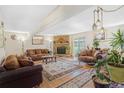 Spacious living room with a stone fireplace, hardwood floors, and sliding glass doors at 42 S Moline St, Aurora, CO 80012