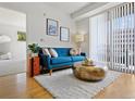 Comfortable living room features modern furnishings, area rug, and natural light with a balcony view at 9019 E Panorama Cir # D204, Englewood, CO 80112