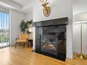Cozy living room boasts a fireplace, neutral tones, and a deer head mount at 9019 E Panorama Cir # D204, Englewood, CO 80112