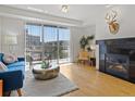 Bright living room featuring a fireplace, balcony, and a comfortable seating area with nice decor at 9019 E Panorama Cir # D204, Englewood, CO 80112
